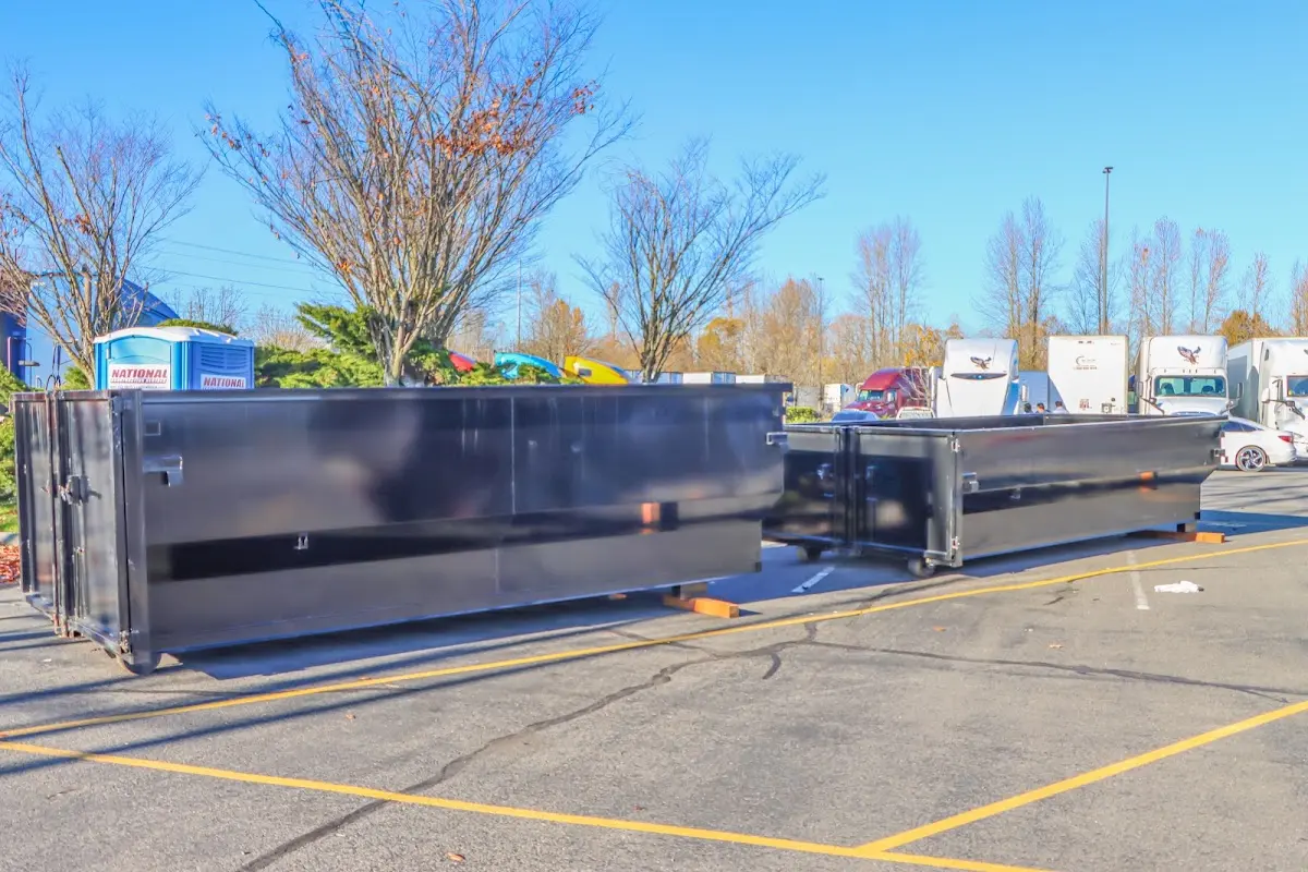Professional dumpster rental service with roll-off container on residential driveway in Hillside